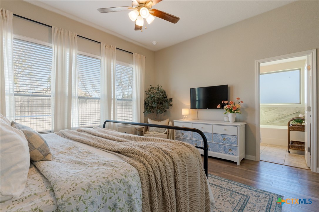 7320 Hammermill Lane Temple, TX 76502 - Photo 15 of 32 a bedroom with a bed and a flat screen tv