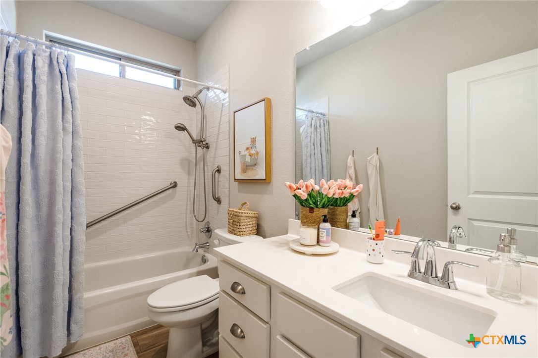 7320 Hammermill Lane Temple, TX 76502 - Photo 23 of 32 a bathroom with a granite countertop sink toilet and shower