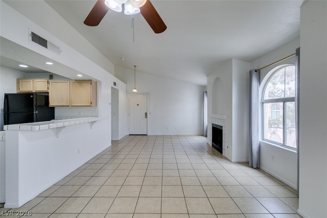 7570 West Flamingo Road, Unit 252 Las Vegas, NV 89147 - Photo 17 of 44 A spacious common area with vaulted ceilings and a cozy fireplace creates an inviting atmosphere.