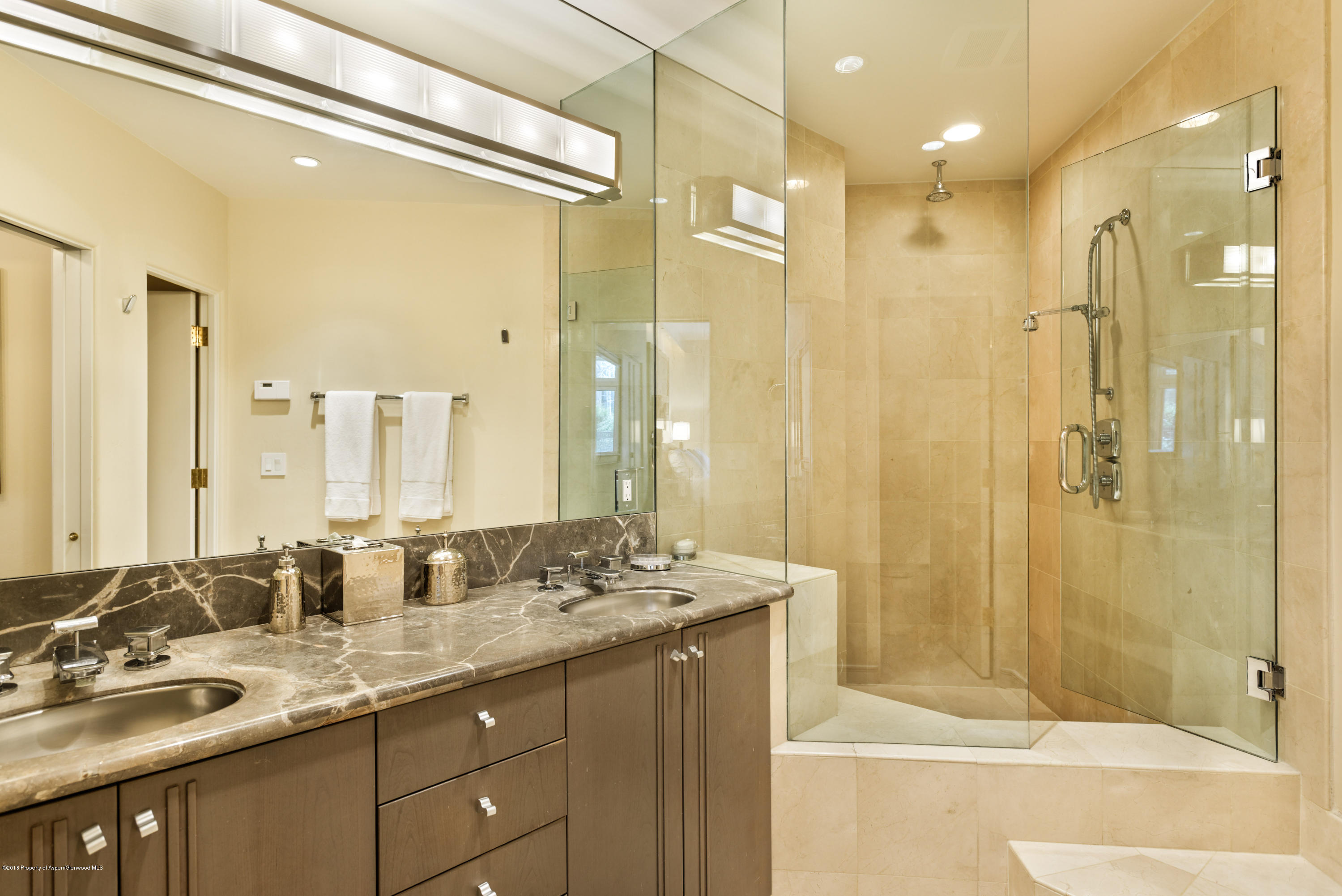 926 East Durant Avenue, Unit 3 Aspen, CO 81611 - Photo 13 of 20 a bathroom with a granite countertop sink mirror and shower