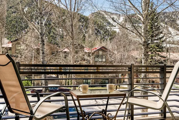 a view of a chairs and table on the roof