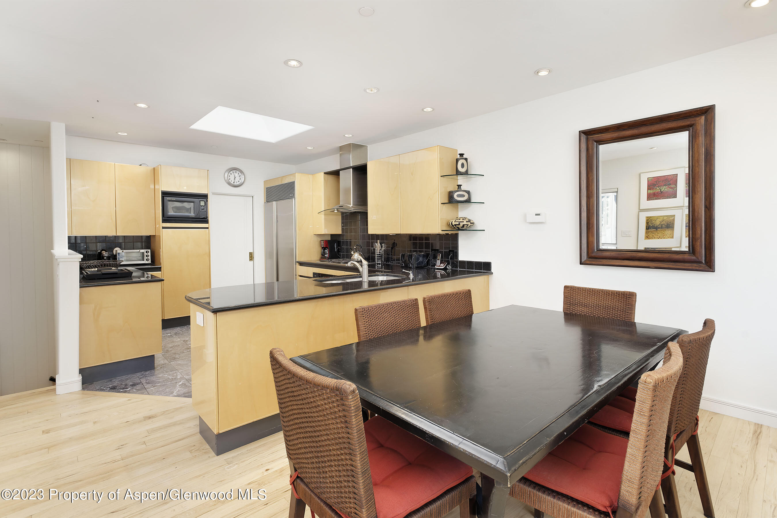 926 East Durant Avenue, Unit 3 Aspen, CO 81611 - Photo 4 of 20 a kitchen with stainless steel appliances granite countertop a stove a sink a dining table and chairs