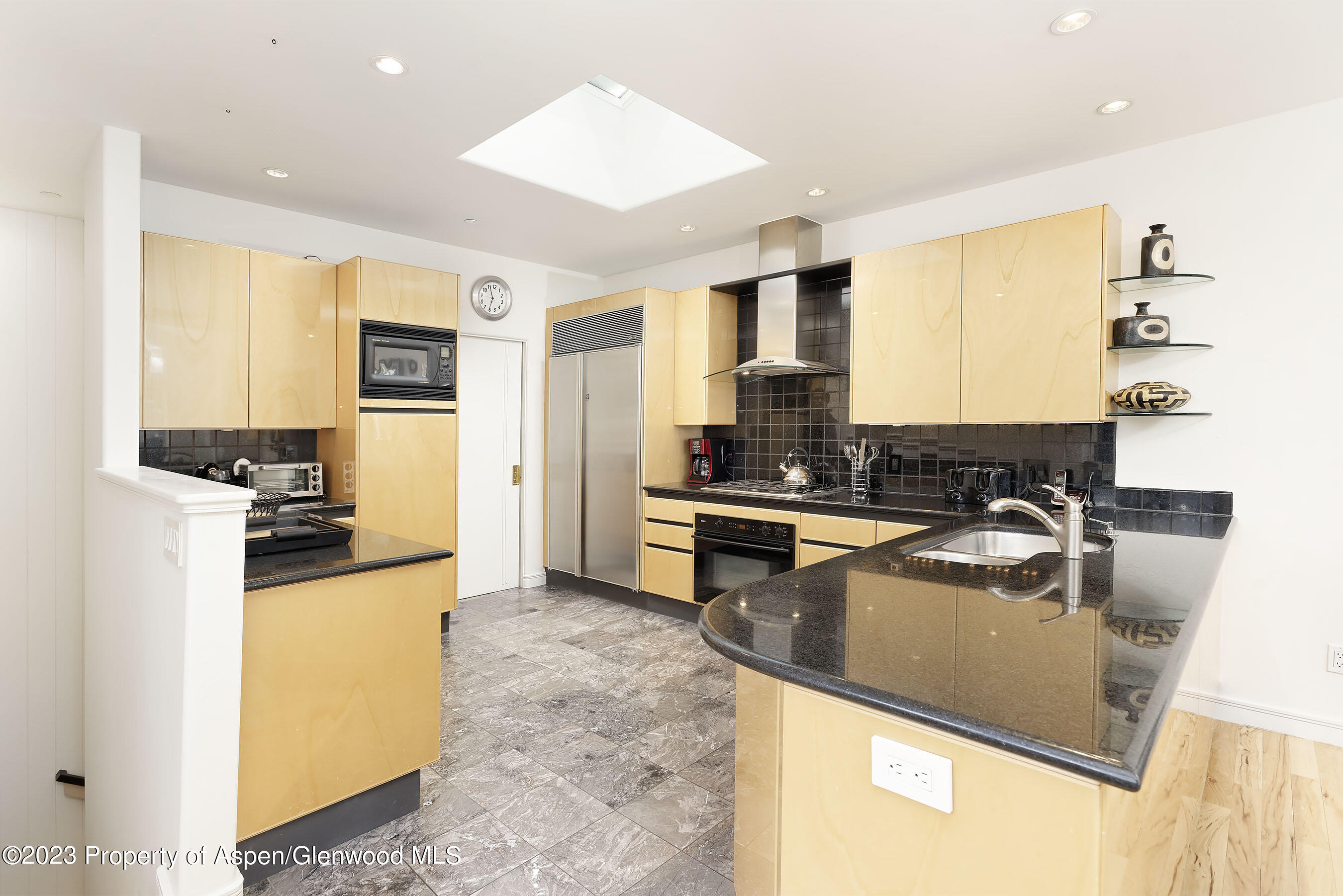 926 East Durant Avenue, Unit 3 Aspen, CO 81611 - Photo 5 of 20 a kitchen with stainless steel appliances granite countertop a sink stove and refrigerator