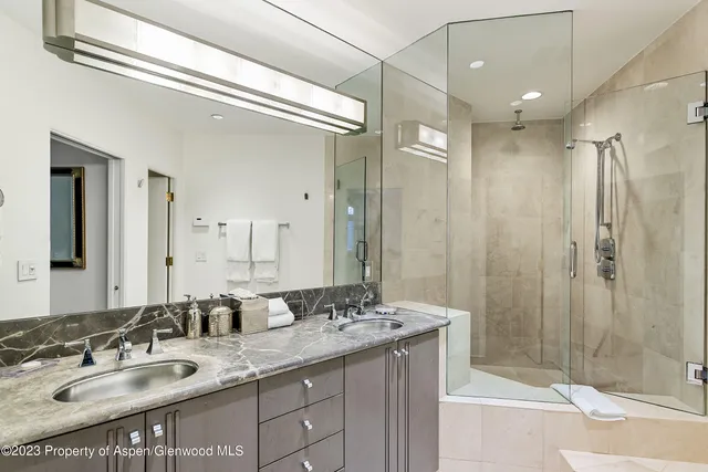 a bathroom with a granite countertop sink shower and a mirror