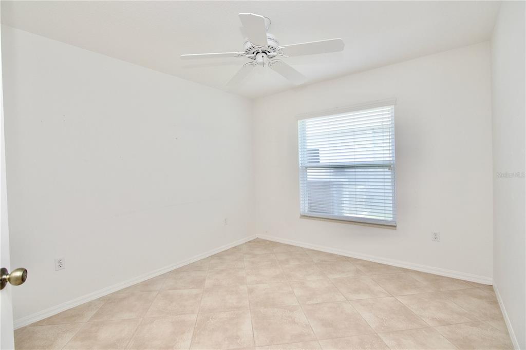 7842 Tenby Court New Port Richey, FL 34655 - Photo 8 of 27 an empty room with a window and a fan