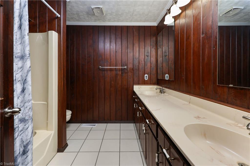 7362 Volunteer Rescue Road Denton, NC 27239 - Photo 25 of 50 Hall bath with double vanity and tile floor