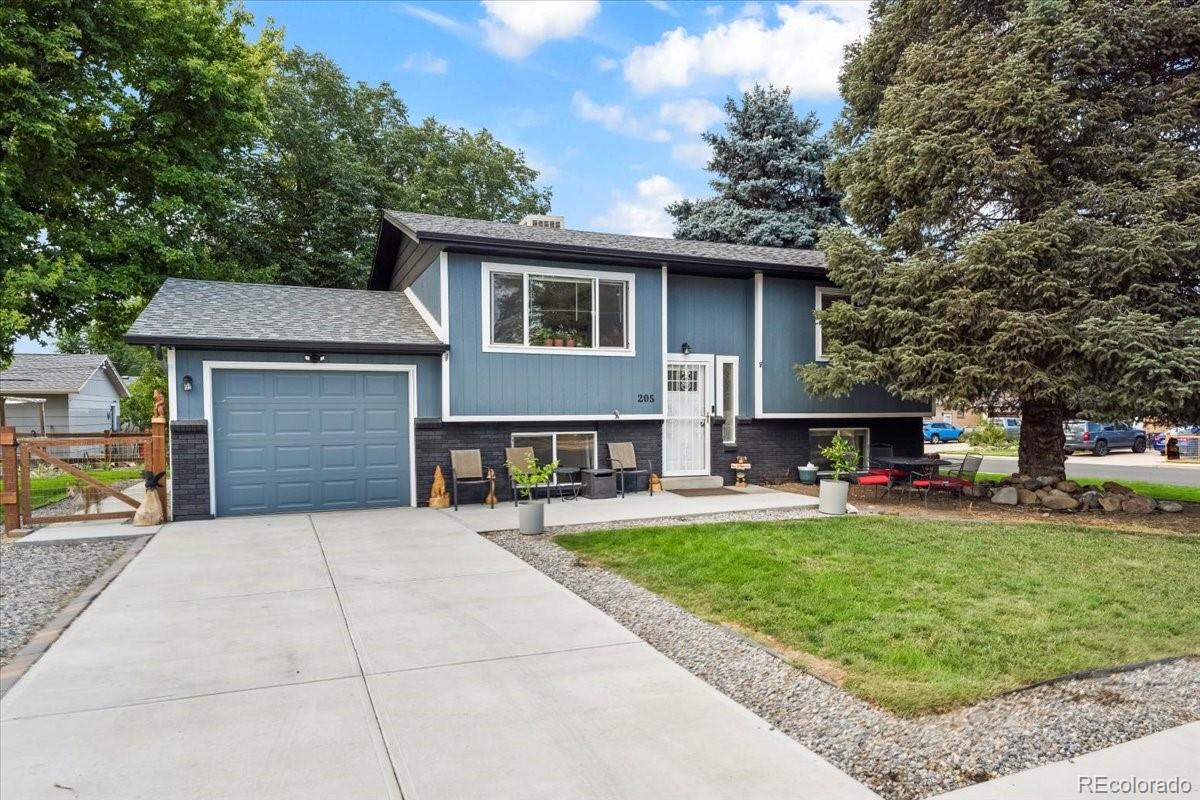 205 Walnut Street Frederick, CO 80530 - Photo 1 of 31 a front view of a house with a garden and trees