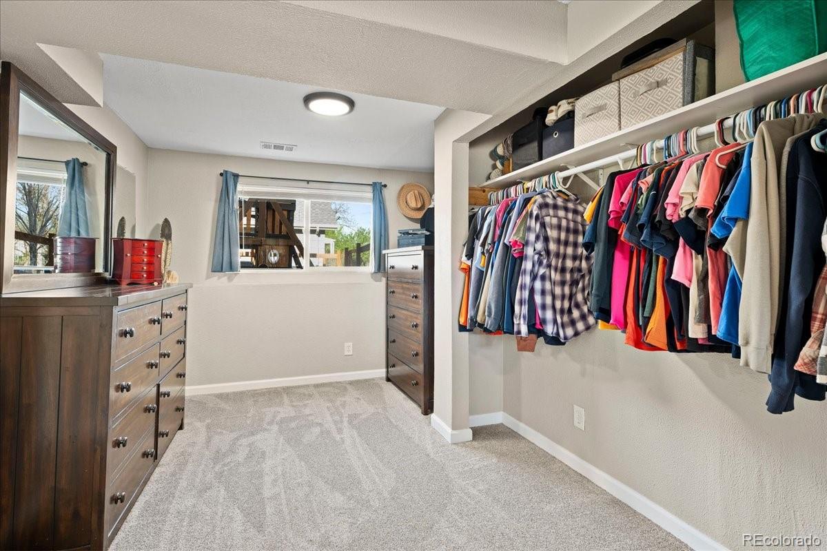 205 Walnut Street Frederick, CO 80530 - Photo 17 of 31 a view of walk in closet with clothes and shoes