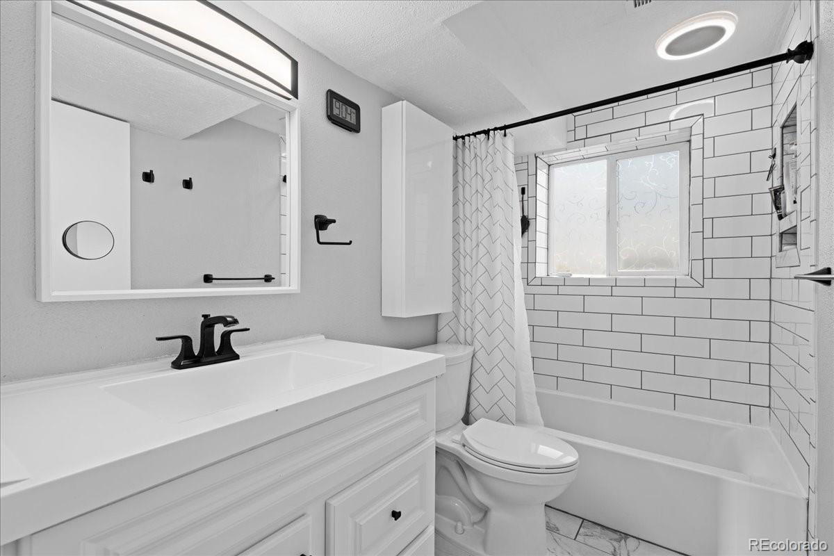 205 Walnut Street Frederick, CO 80530 - Photo 18 of 31 a bathroom with a sink a toilet and shower