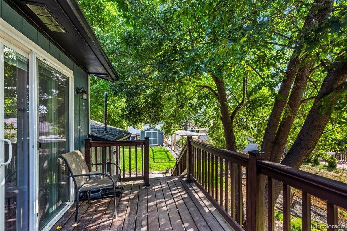 205 Walnut Street Frederick, CO 80530 - Photo 24 of 31 a view of a balcony with chairs and wooden floor
