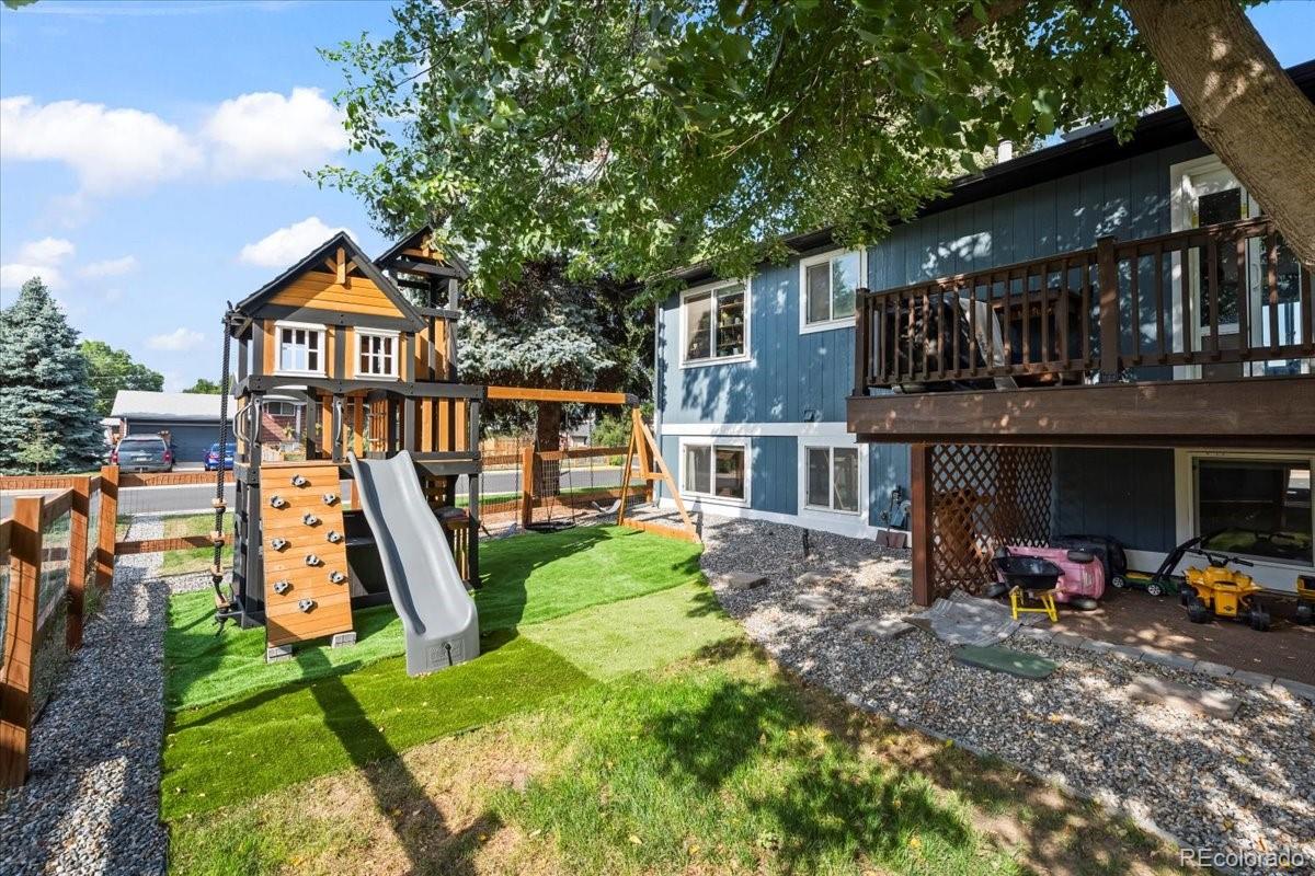 205 Walnut Street Frederick, CO 80530 - Photo 29 of 31 a view of a house with backyard and a slide