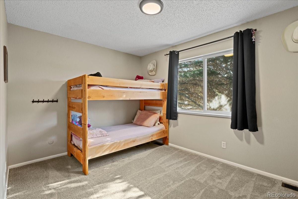 205 Walnut Street Frederick, CO 80530 - Photo 10 of 31 a bedroom with a bed and a window