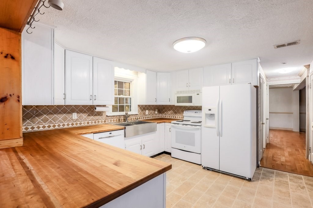 20 Flagg Street Boylston, MA 01505 - Photo 10 of 39 a kitchen with white cabinets and white appliances