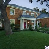 a view of a brick house with a yard