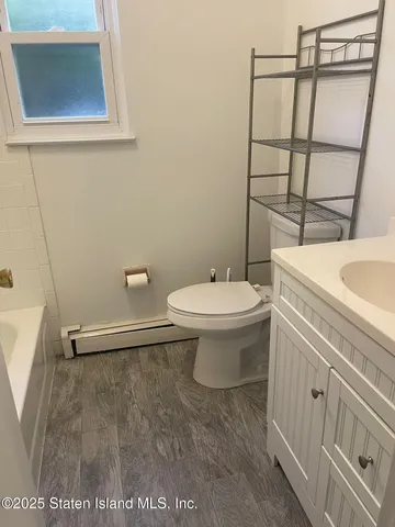 a bathroom with a sink toilet and a mirror