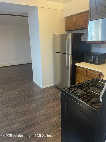 a kitchen with granite countertop a stove and a refrigerator