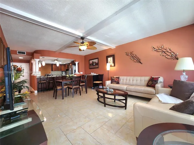 a living room with furniture a dining table and chairs