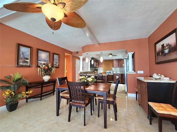 a view of a dining room with furniture and chandelier