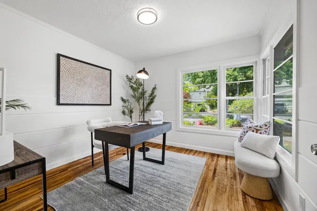 a living room with furniture a table and a large window