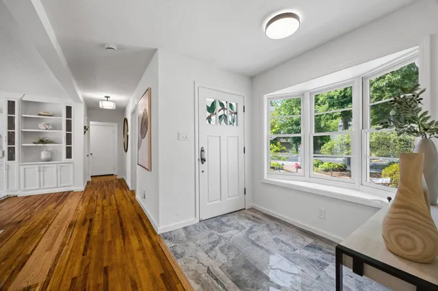 a view of a livingroom with furniture window and wooden floor