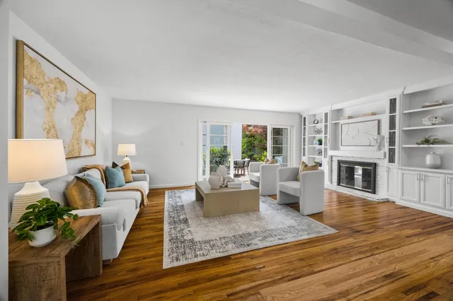a living room with fireplace furniture and a fireplace