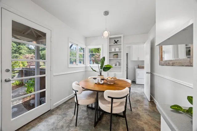 a dining room with furniture and window