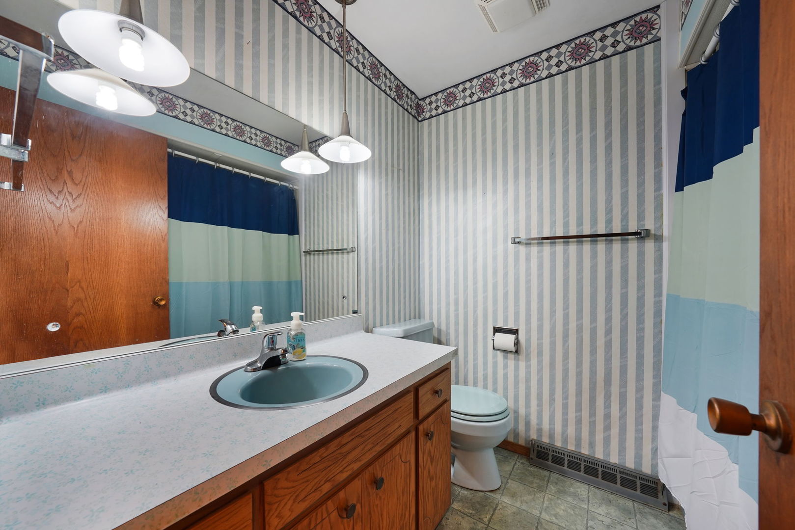 10626 North Grove Road Sycamore, IL 60178 - Photo 20 of 28 a bathroom with a sink a toilet and a mirror