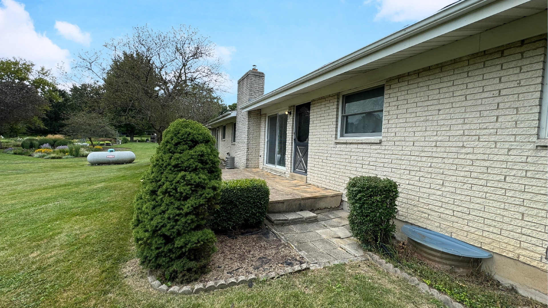 10626 North Grove Road Sycamore, IL 60178 - Photo 23 of 28 a backyard of a house with plants and outdoor seating