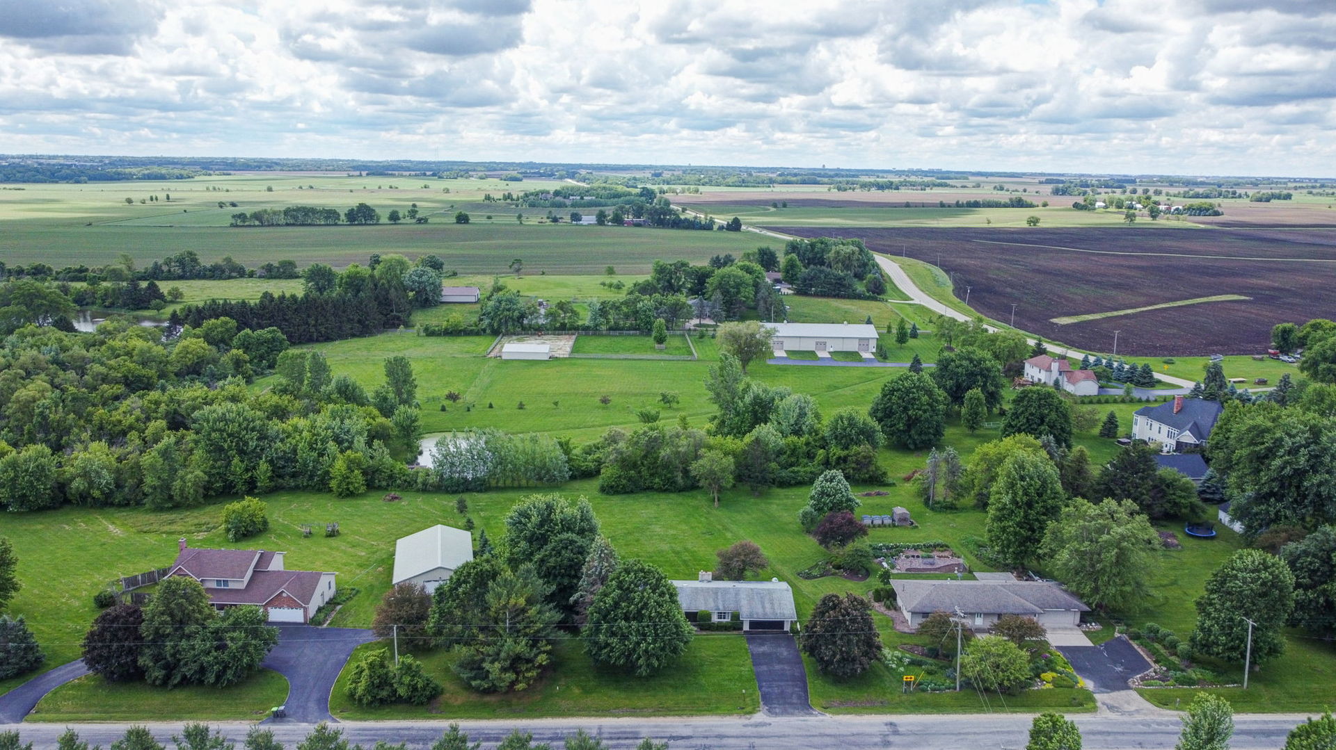 10626 North Grove Road Sycamore, IL 60178 - Photo 26 of 28 an aerial view of a city with lots of residential buildings and mountain view in back