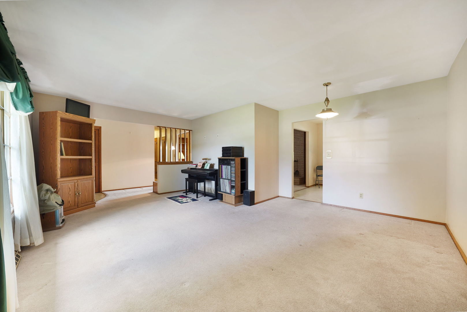 10626 North Grove Road Sycamore, IL 60178 - Photo 4 of 28 an empty room with furniture and a ceiling fan