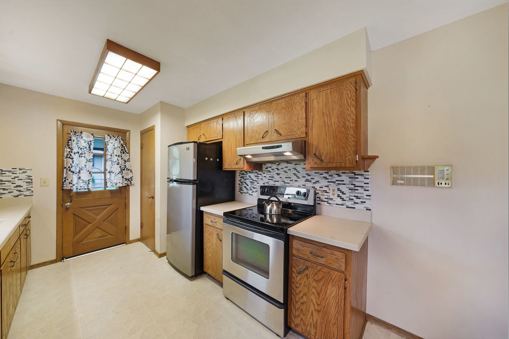 10626 North Grove Road Sycamore, IL 60178 - Photo 8 of 28 a kitchen with stainless steel appliances a stove a refrigerator and a sink