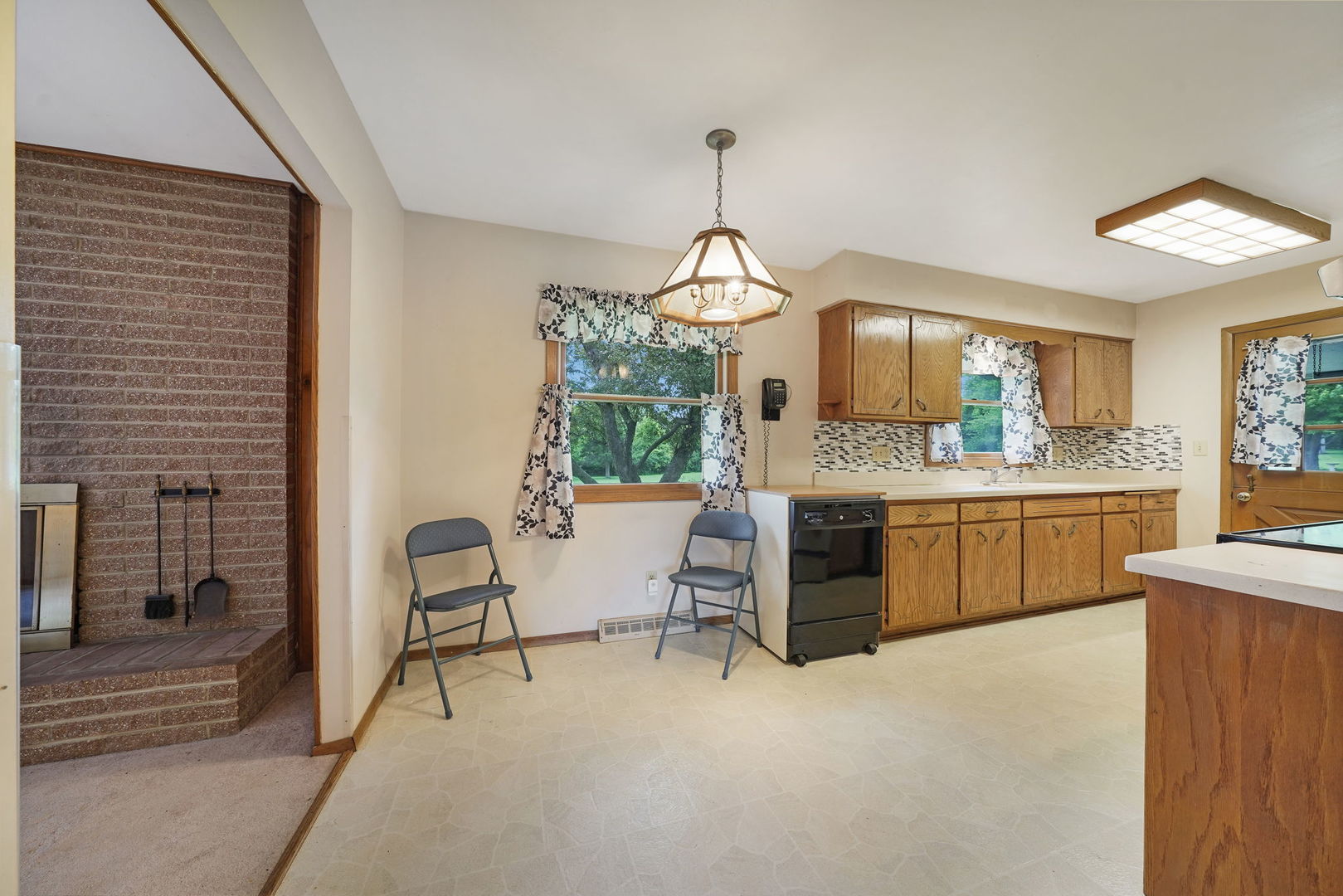 10626 North Grove Road Sycamore, IL 60178 - Photo 10 of 28 a large kitchen with kitchen island a large counter space a sink stainless steel appliances and cabinets