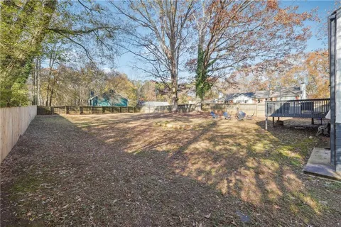 a view of dirt yard with a large tree