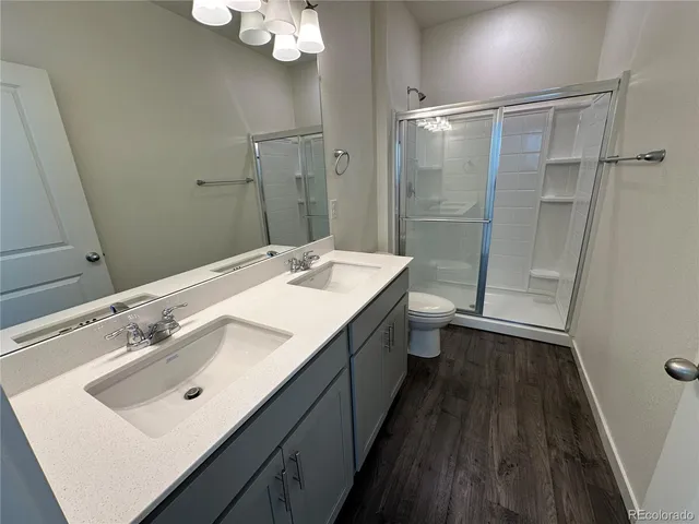 a bathroom with a double vanity sink mirror double vanity and toilet