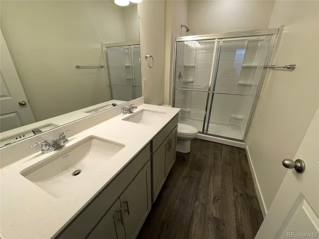 a bathroom with a double vanity sink a and mirror