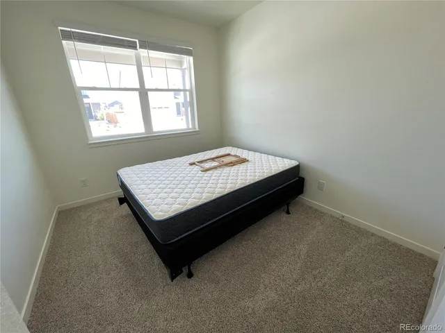 a room with a bed and a window