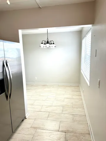 a view of hallway with an empty room