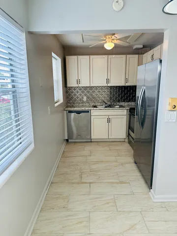 a kitchen with granite countertop a stove and a microwave