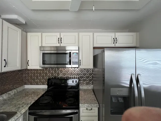 a stove top oven sitting inside of a kitchen