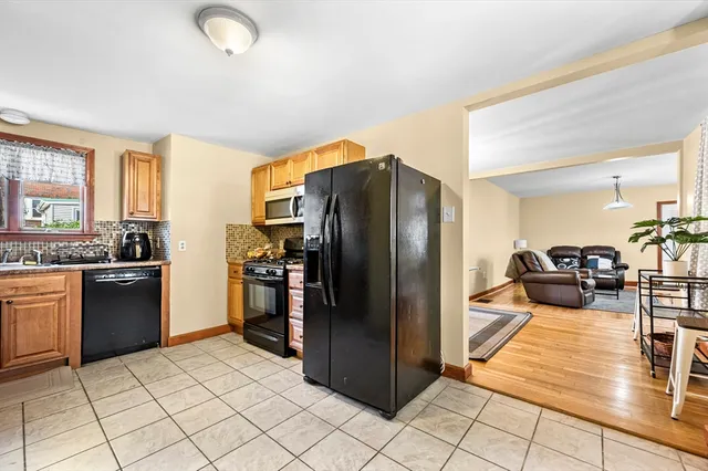 a kitchen with stainless steel appliances granite countertop a refrigerator and a sink