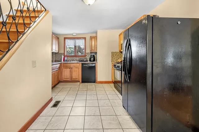 a kitchen with stainless steel appliances granite countertop a refrigerator and a sink