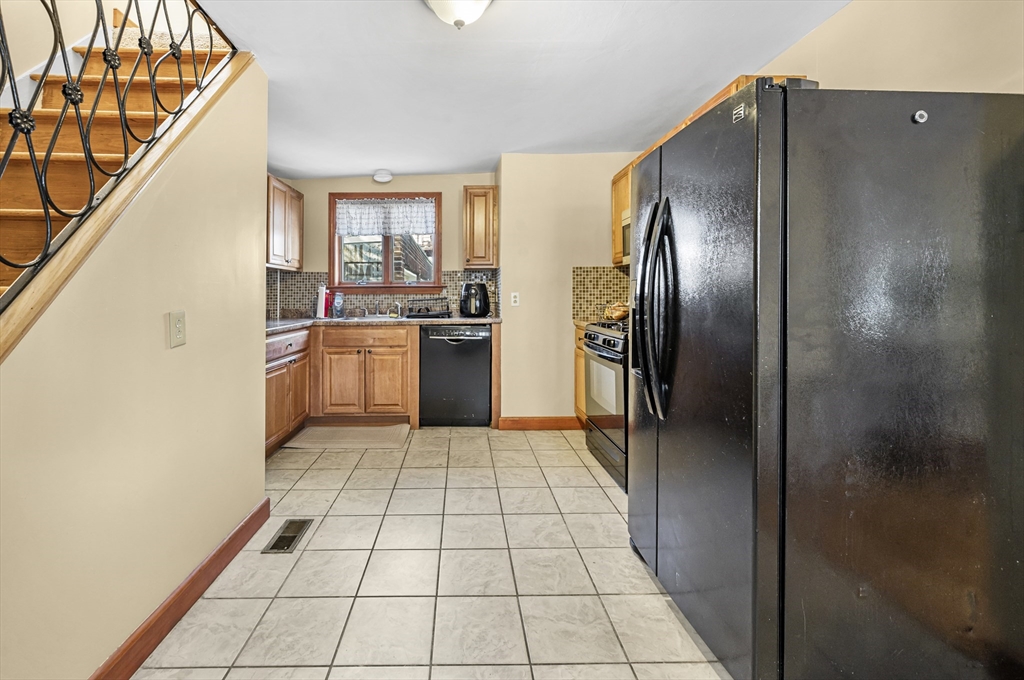 50 Temple Street, Unit 50 Somerville, MA 02145 - Photo 12 of 41 a kitchen with stainless steel appliances granite countertop a refrigerator and a sink