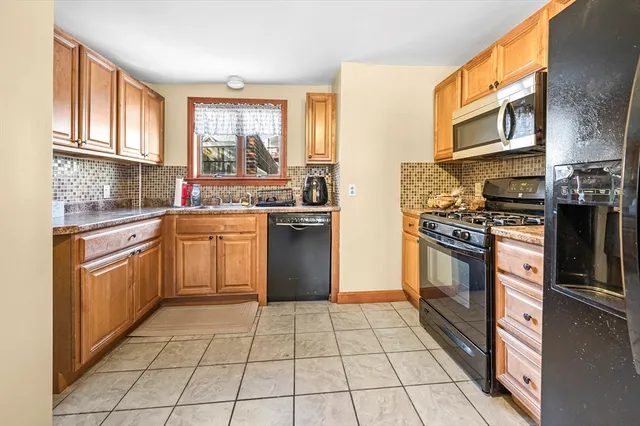 a kitchen with stainless steel appliances granite countertop a stove a sink dishwasher and a refrigerator