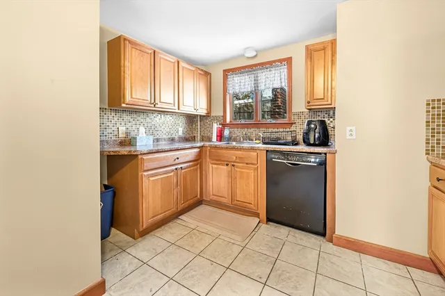 a kitchen with a sink cabinets and window