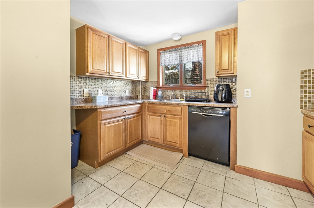 50 Temple Street, Unit 50 Somerville, MA 02145 - Photo 14 of 41 a kitchen with a sink cabinets and window