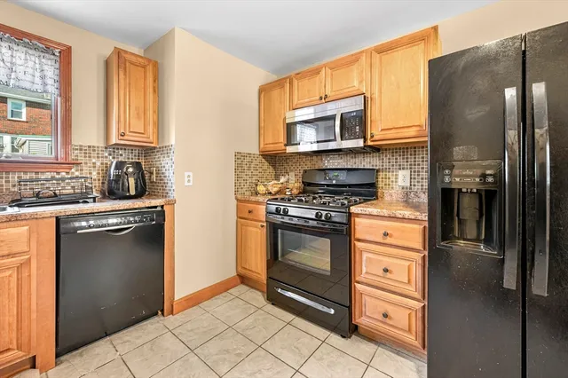 a kitchen with stainless steel appliances granite countertop a refrigerator stove and sink