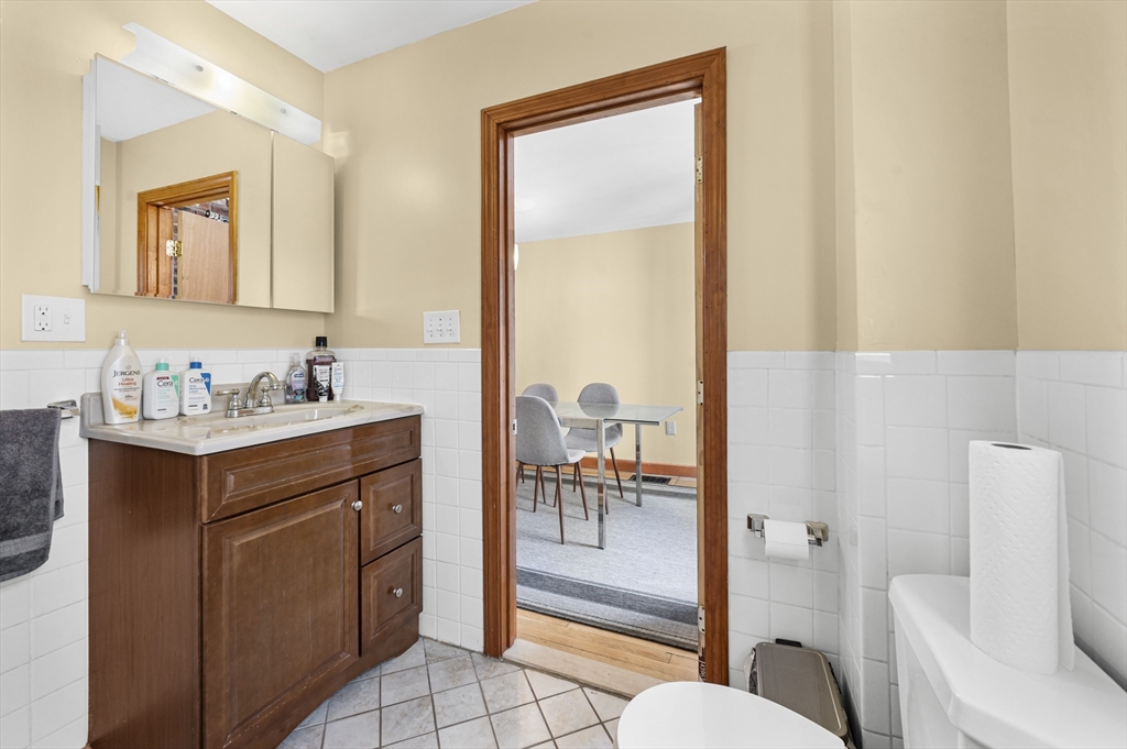 50 Temple Street, Unit 50 Somerville, MA 02145 - Photo 16 of 41 a bathroom with a granite countertop sink and a mirror