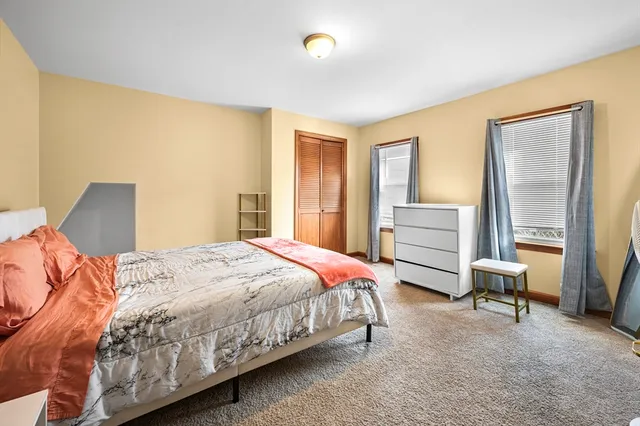 a bedroom with a bed and a desk