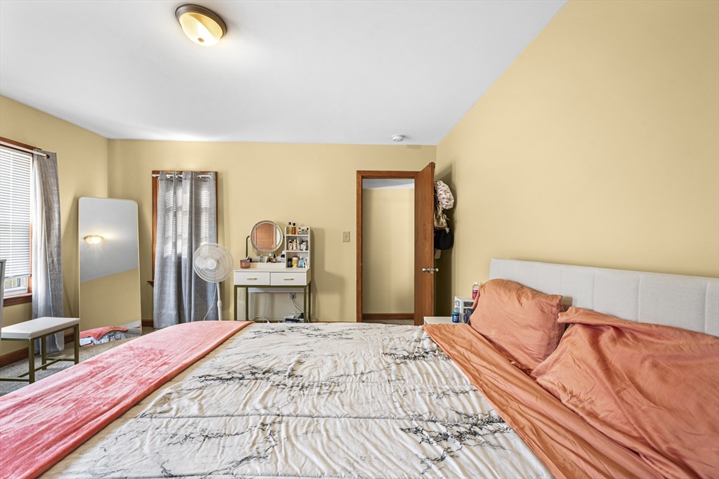 50 Temple Street, Unit 50 Somerville, MA 02145 - Photo 24 of 41 a bedroom with a bed and a chandelier