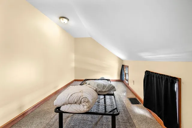 a bedroom with furniture and a gate